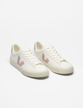 white low top VEJA sneakers with a pink logo detailing.